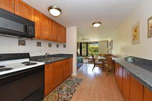 a kitchen with a sink and a stove top oven at Kaleialoha 402 · KA 402 Spacious Studio Close to Ocean Heated Po in Kahana