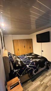 a bedroom with a bed and a flat screen tv at Vélez Loft in Vélez