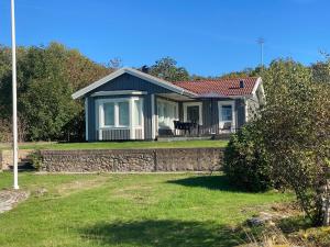 a small house with a stone wall at Seaside Home with Stunning Views Overlooking Blekinge Archipelago in Ronneby