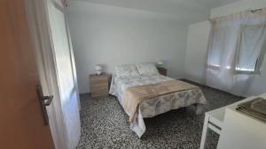 a bedroom with a bed and a dresser and a window at Casa Sol in Santiago de la Ribera