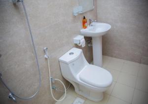 a bathroom with a shower and a toilet and a sink at Havah Zanzibar Home in Mwanakwerekwe