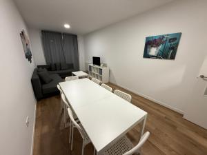 a living room with a white table and chairs at Vut ILLA PANCHA in Ribadeo