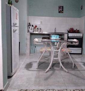 a kitchen with a table and a refrigerator at Casa Ariana I in Federación
