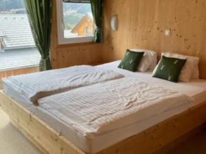 a large bed in a bedroom with a window at The Laerch in Hohentauern