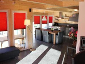 a kitchen with red blinds on the windows and a table at The Laerch in Hohentauern