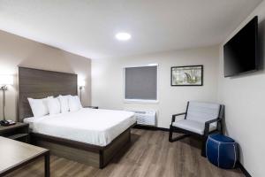 a hotel room with a bed and a chair at Extended Stay America Suites - Columbia - Greystone in Columbia