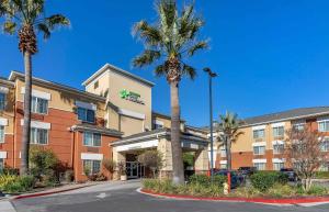 a hotel with palm trees in front of a building at Extended Stay America Suites - San Francisco - San Carlos in San Carlos