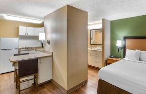 a hotel room with a bed and a kitchen and a bed and a desk at Extended Stay America Suites - San Francisco - San Carlos in San Carlos