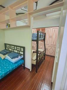 a room with two bunk beds in a room at Transient in Davao City