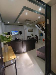 a lobby with a staircase and a living room at Transient in Davao City +20 photos