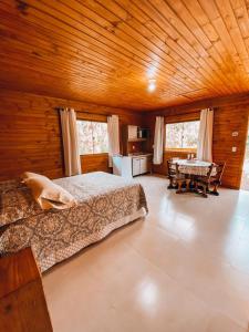 a bedroom with a bed and a table in a room at cabanasbomjesus in Santo Amaro da Imperatriz