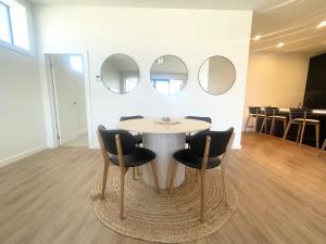 una mesa y sillas en una habitación con espejos en Love Our Loft, en Napier 12 fotos más