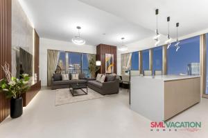 a rendering of a living room and dining room at SML Vacation Homes - Sky High Apartments with Burj Khalifa and Dubai Fountain Views at Grande Signature, Downtown Dubai in Dubai +60 photos