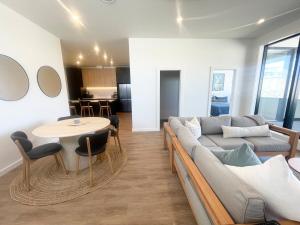 a living room with a couch and a table at Love Our Loft in Napier