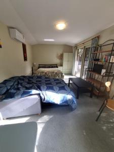 a bedroom with a bed and a ladder at Garden Dreams bungalow in Blackburn