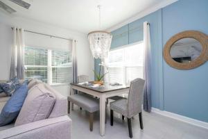 a dining room with a table and a couch at NEW to Market 5 Bed - Storey Lake Retreat in Kissimmee