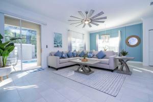 a living room with a couch and a table at NEW to Market 5 Bed - Storey Lake Retreat in Kissimmee