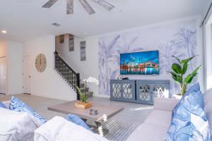 a living room with a couch and a tv at NEW to Market 5 Bed - Storey Lake Retreat in Kissimmee