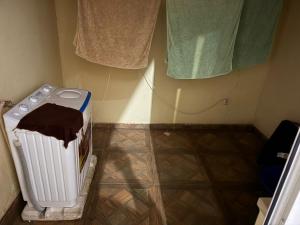 a laundry room with a radiator and some towels at vitoria in Praia