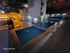 a swimming pool in a building at night at Cleopatra City Hotel Alanya in Alanya +259 photos