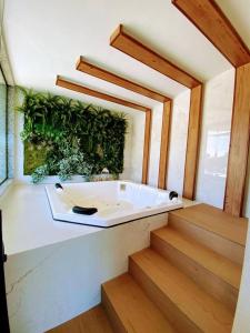 a bath tub in a bathroom with a green wall at SouMaisTemporada RJ in Niterói