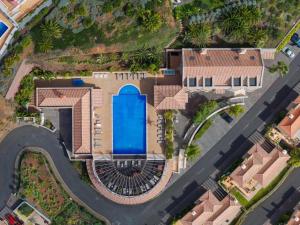 an overhead view of a house with a swimming pool at Balancal Apartments and Villas Palheiro Village in Funchal