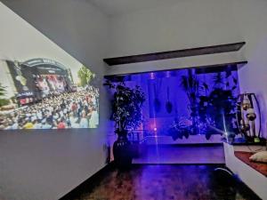 a room with a painting on a wall with purple lights at Beautiful Rooms at Villa La Floresta in Ajijic
