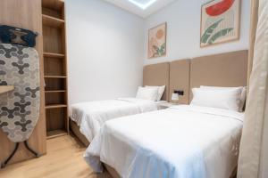 a room with two beds and a closet at Welcomly 10 - Luxury apartment in Tangier in Tangier