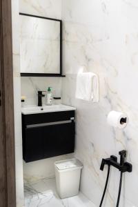 a white bathroom with a sink and a toilet at Welcomly 10 - Luxury apartment in Tangier in Tangier +21 photos