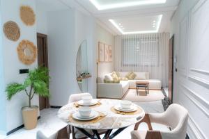 a living room with a table and chairs at Welcomly 10 - Luxury apartment in Tangier in Tangier