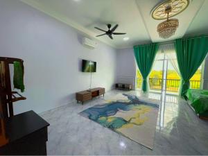 a living room with a couch and a ceiling fan at Bunohan Villa Homestay in Tumpat