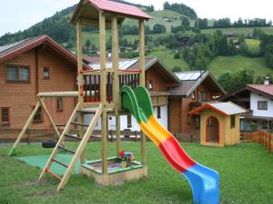 a playground with a slide in a yard at Feriendorf Wildschönau with private garden, cleaning included in Niederau