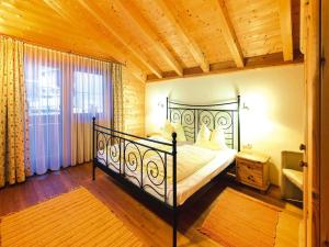 a bedroom with a black bed in a room at Feriendorf Wildschönau with private garden, cleaning included in Niederau