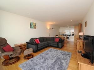 a living room with a couch and a tv at Tidal Bay in Westward Ho
