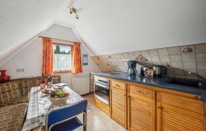 a kitchen with a table with a bowl of fruit on it at Ferienwohnung Neuhermsdorf in Neuhermsdorf