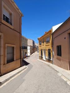 an empty street in a town with buildings at CASA RURAL ALEGRÍA in Caudete de las Fuentes +36 photos