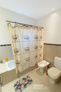 Un baño con inodoro y cortina de ducha en Casa moderna en Valeria del Mar, en Valeria del Mar