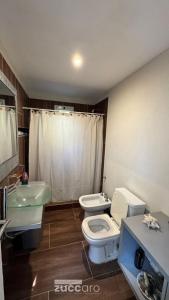 a bathroom with two toilets and a sink at Casa moderna en Valeria del Mar in Valeria del Mar
