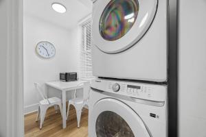 a laundry room with a washing machine and a table at Pittsburgh Shadyside 1D Stylish and Cozy Private Bedroom with Shared Bathroom in Pittsburgh +3 photos
