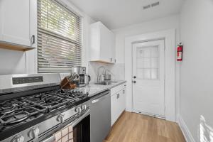 a kitchen with white cabinets and a stove top oven at Pittsburgh Shadyside 1D Stylish and Cozy Private Bedroom with Shared Bathroom in Pittsburgh