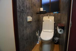 a bathroom with a white toilet in a room at 和風グランピング LYS AIBA House 一 Japanese Garden Villa in Takashima +4 photos