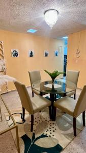 a dining room with a glass table and chairs at Jacuzzi Hideaway in San Juan +5 photos