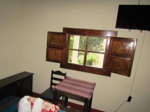 a room with a table and a window and a chair at Casa Calvario in Antigua Guatemala