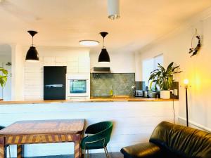 a kitchen with a wooden table and a counter at 2Br Apartment, Pool, 12 mins to Airport in Bilambil Heights