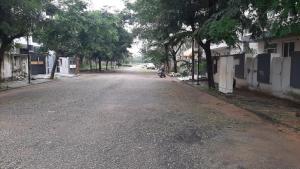 an empty street with a motorcycle parked on the side of the road at Riddhi Homestay in Dahmi