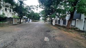 an empty street with trees on both sides of the road at Riddhi Homestay in Dahmi