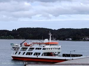 un gran barco está atracado en el agua en Hospedaje Mirador del Puerto, en Quellón