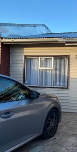 a silver car parked in front of a house at Casa Refugio Austral, hasta 6 personas, cerca Mall Pionero, Zona Franca y Centro in Punta Arenas
