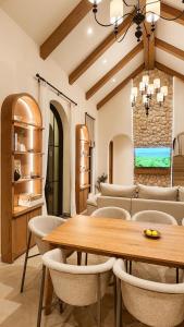 a dining room with a wooden table and chairs at La Moon Da Villa Khaoyai in Ban Bung Toei