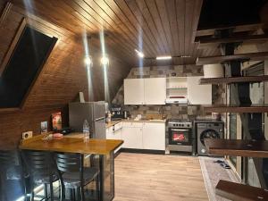 a kitchen with a table and a stove at Umm Aljulud Cottages 01 in Ajloun